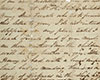 Une lettre écrite à la main et à l’encre noire, sur du papier qui a jauni, maculée de marques blanches et de taches brunes.
