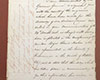 Lettre manuscrite à l’encre noire sur du papier bruni, hachuré dans la marge de gauche.