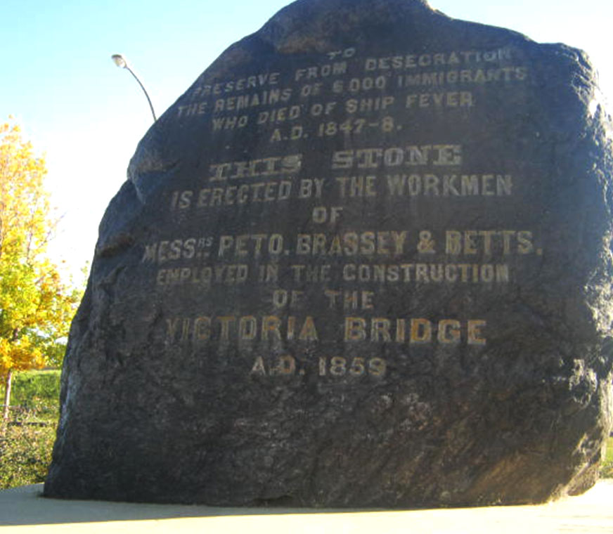 Black Rock with inscription: To Preserve from Desecration the Remains of 6000 Immigrants who Died of Ship Fever. A.D. 1847-8. This Stone is Erected by the Workmen of Messrs Peto. Brassey & Betts. Employed in the Construction of the Victoria Bridge. A.D. 1859.