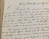 Handwritten letter on white paper with slight shadow in upper left corner. Grey background top left.