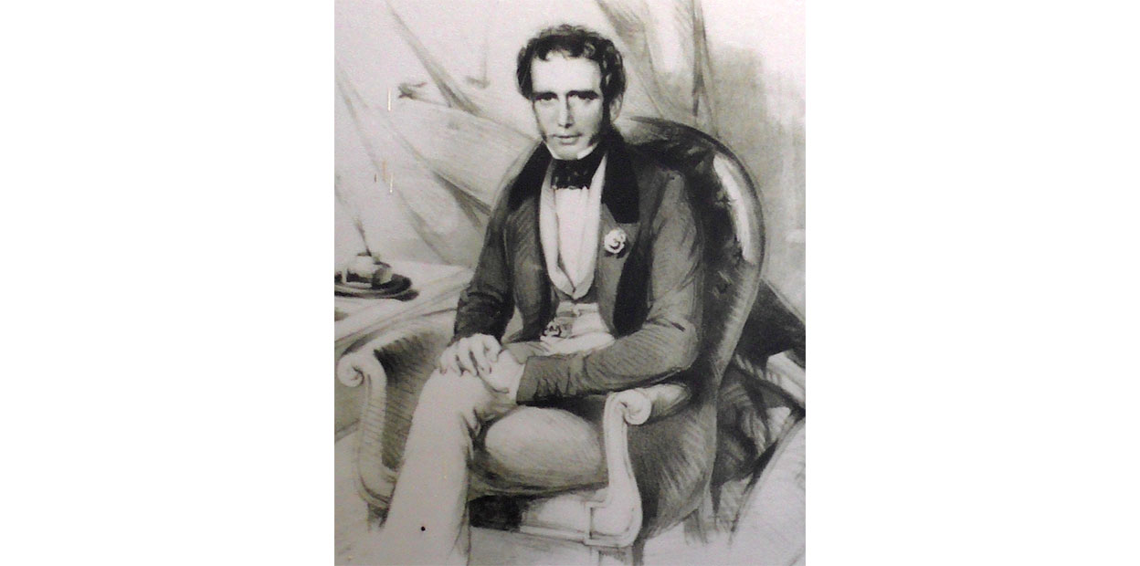 Black and white illustrated portrait of seated man with curly dark hair and dark eyes, dressed in three piece suit with a cravat and a flower in his left breast pocket. His legs are crossed and he is looking at the viewer.