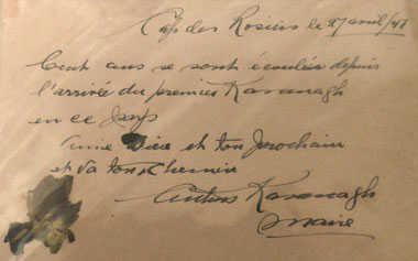 Close up of document held in hand. The document is dated Cap des Rosiers 27th, April 1947. It is handwritten in French.